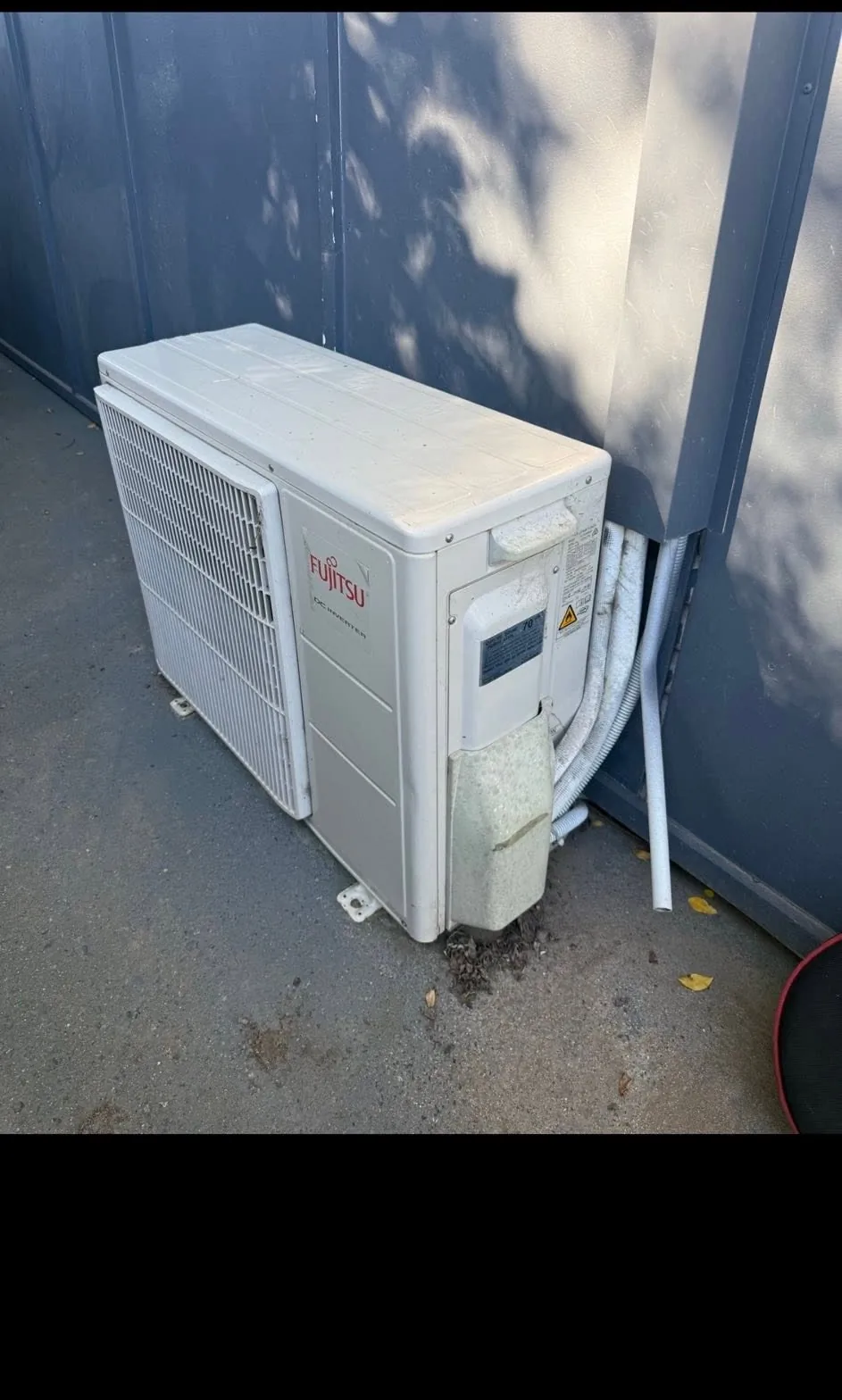 Fujitsu DC Inverter split system outdoor unit installed against a colorbond wall at a Coffs Harbour property