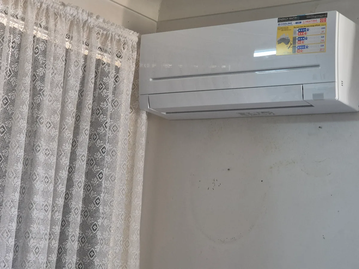 Mitsubishi Electric wall-mounted split system indoor head unit installed high on a wall in a residential home