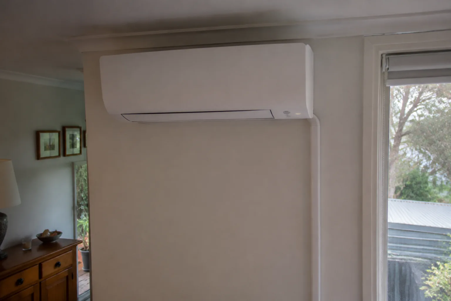 Wall-mounted white split system installed in a coastal Australian home