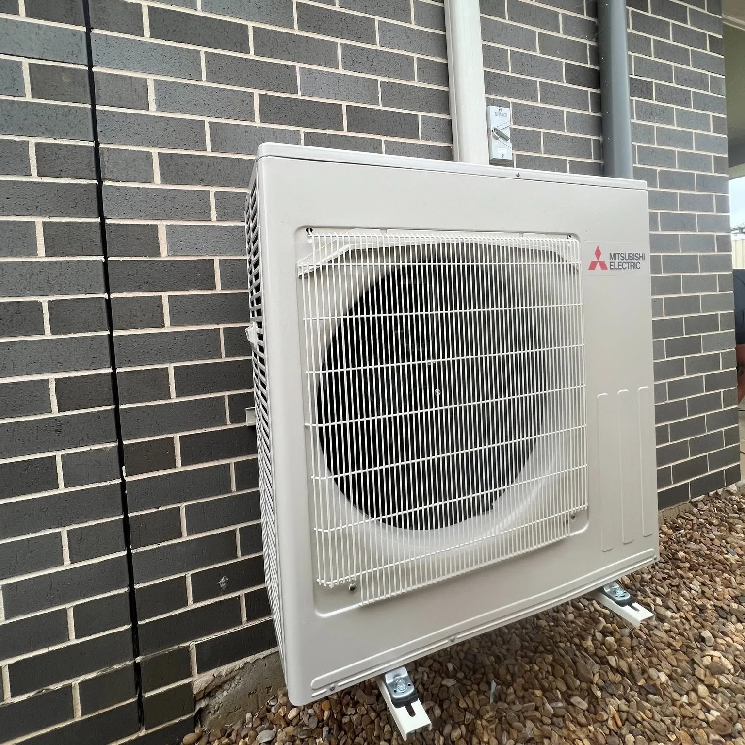 FHC install: outdoor condenser mounted on a wall bracket, Coffs Harbour